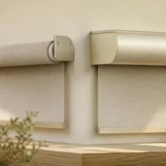 An enclosed aluminium cassette headbox beside a bare open roller tube