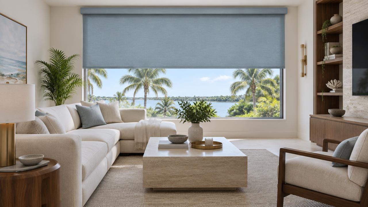 Dusty sky blue motorized roller shade facing a palm-lined Florida view